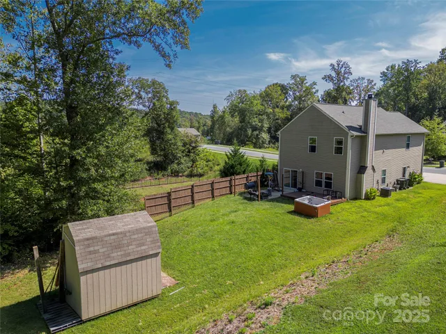 a view of a house with backyard sitting area and garden