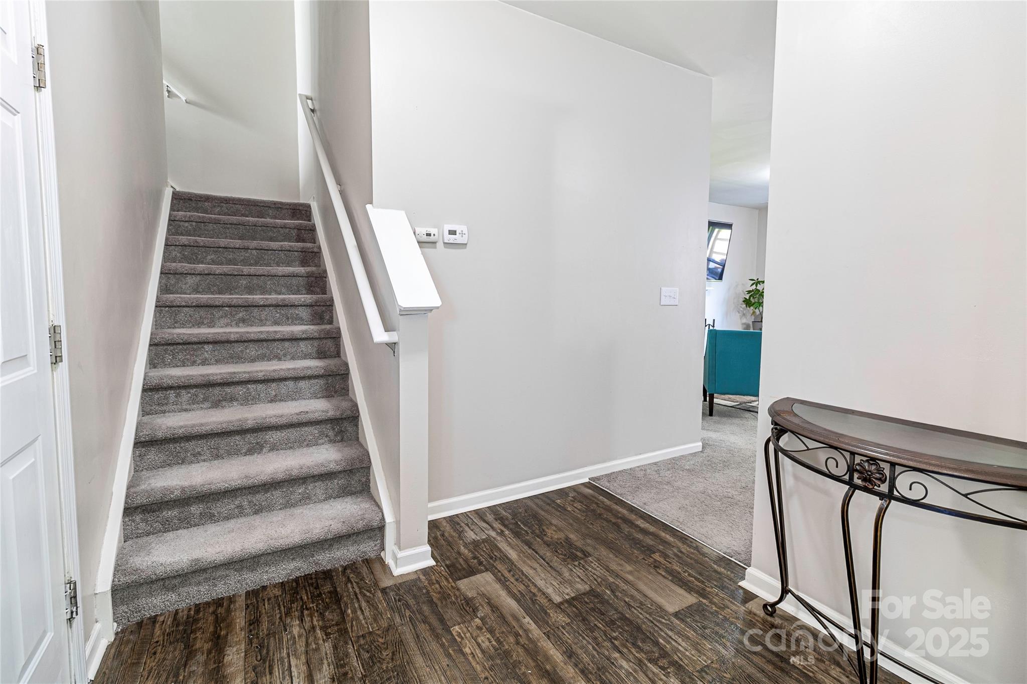 7017 Whitewater Loop Lowell, NC 28098 - Photo 8 of 24 a view of a hallway with wooden floor and staircase