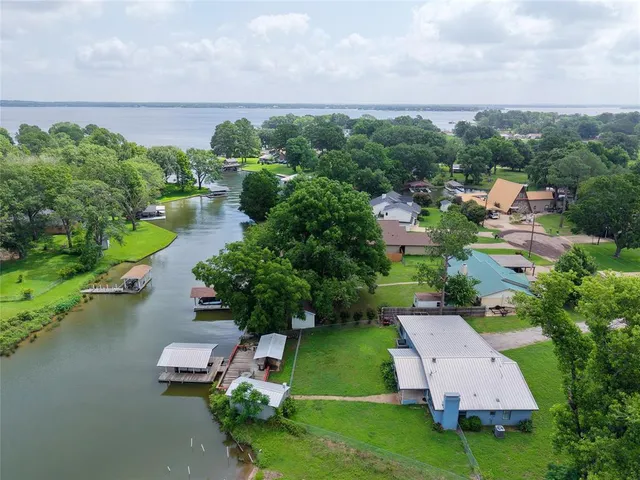 an aerial view of a house with garden space and street view