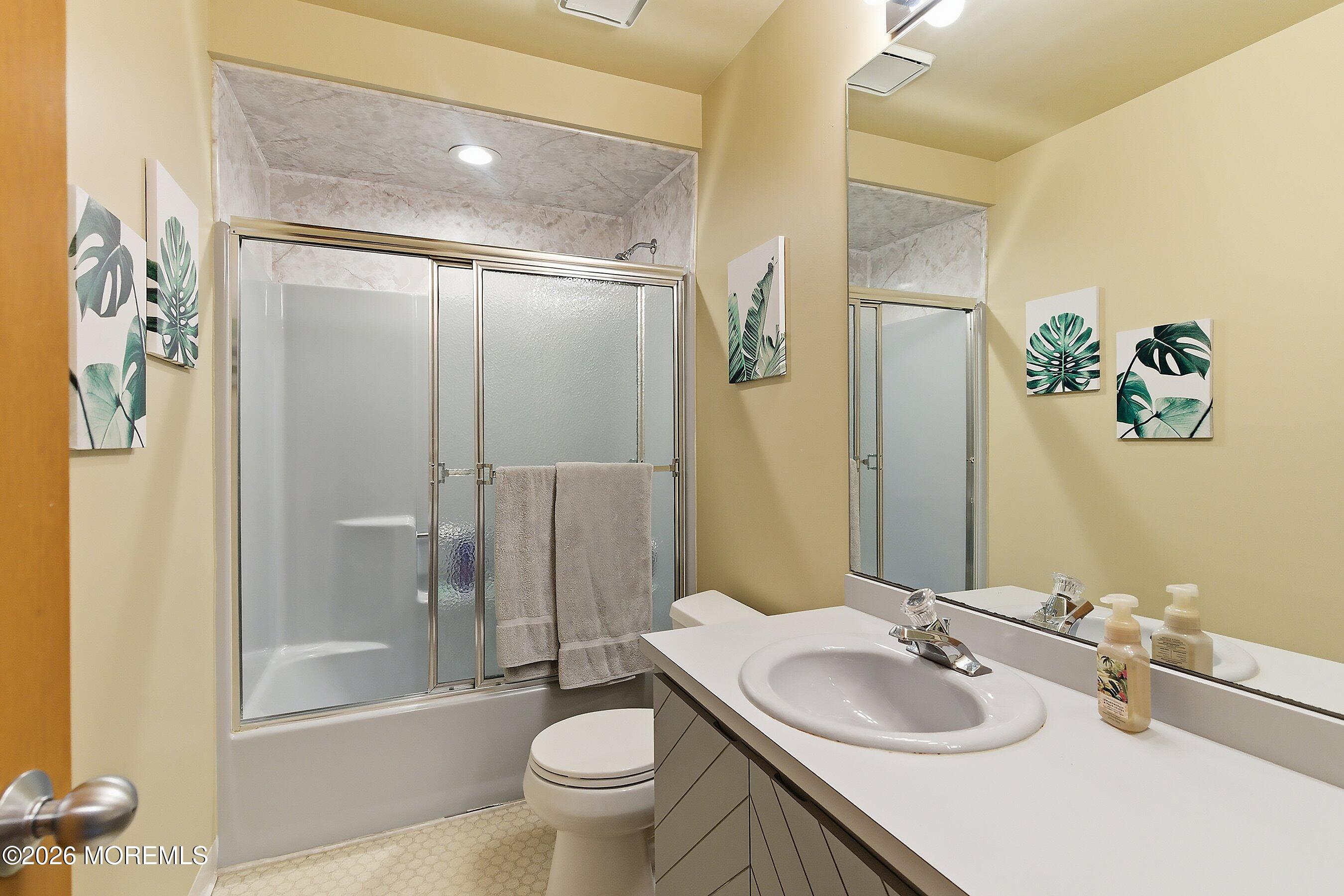 21 Brown Avenue, Unit 1 Lavallette, NJ 08735 - Photo 14 of 28 a bathroom with a granite countertop sink toilet and shower