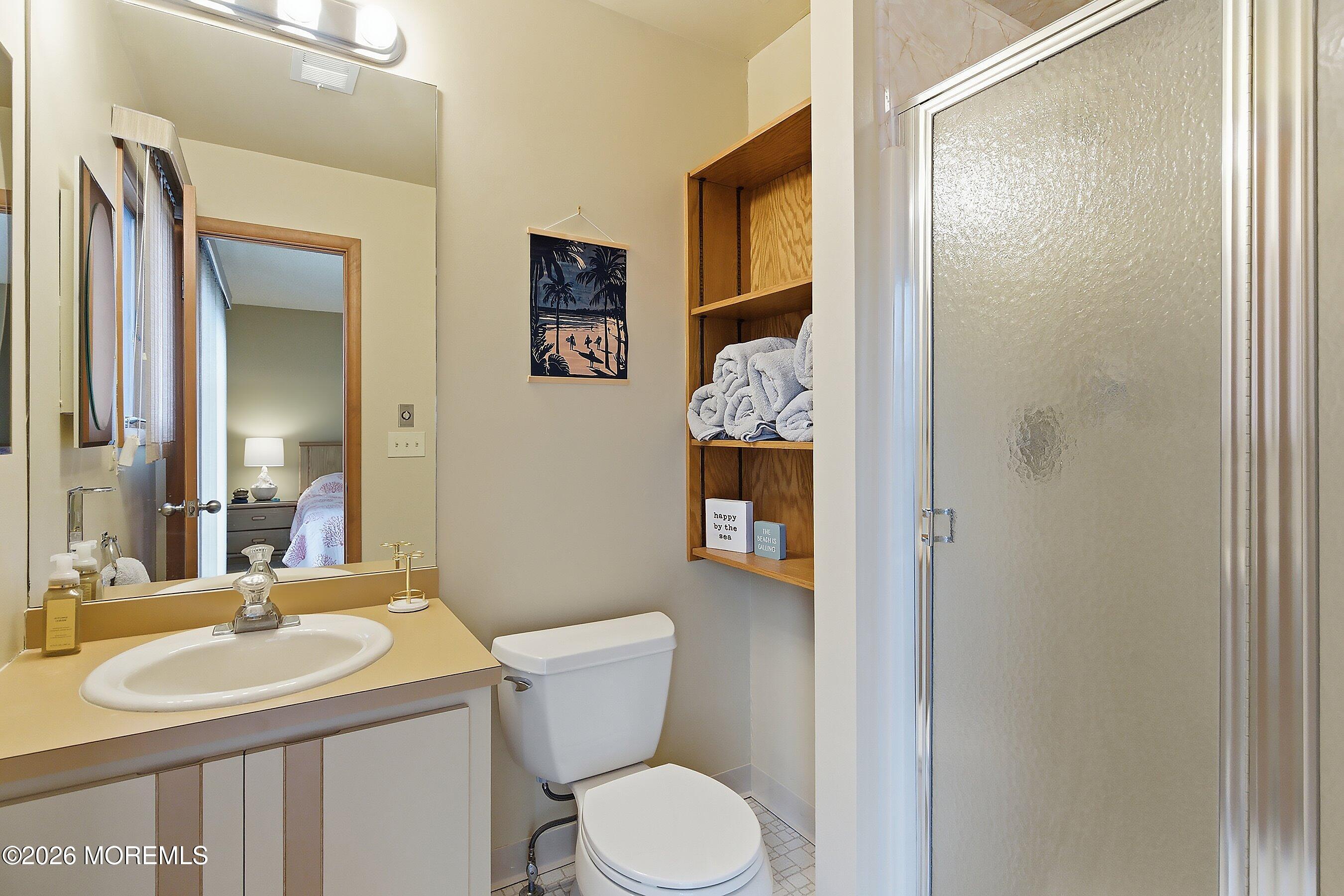 21 Brown Avenue, Unit 1 Lavallette, NJ 08735 - Photo 16 of 28 a bathroom with a toilet sink and mirror
