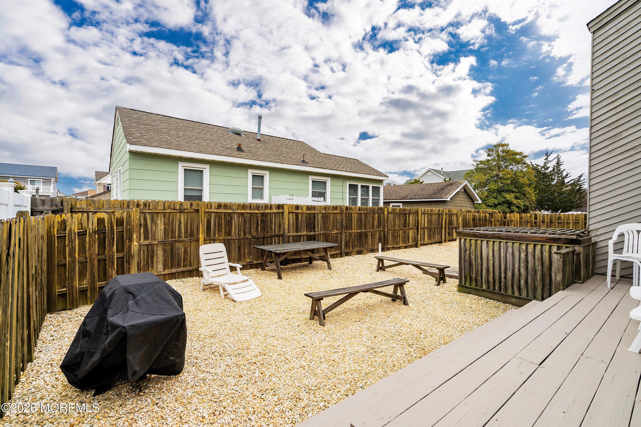 21 Brown Avenue, Unit 1 Lavallette, NJ 08735 - Photo 17 of 28 a view of a roof deck with couches and wooden floor