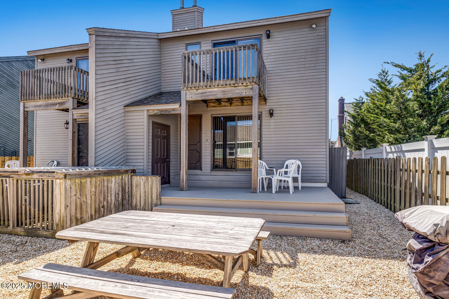21 Brown Avenue, Unit 1 Lavallette, NJ 08735 - Photo 19 of 28 a patio with a table and chairs and wooden fence