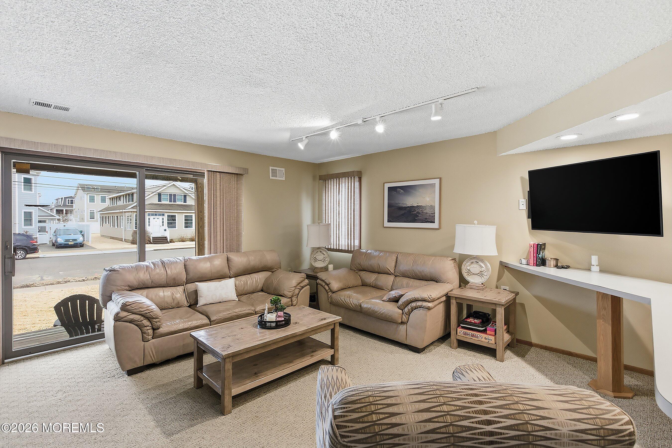 21 Brown Avenue, Unit 1 Lavallette, NJ 08735 - Photo 5 of 28 a living room with furniture and a flat screen tv