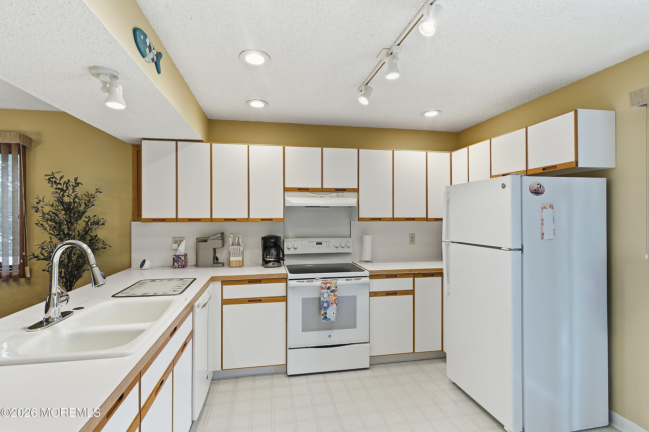 21 Brown Avenue, Unit 1 Lavallette, NJ 08735 - Photo 7 of 28 a kitchen with stainless steel appliances granite countertop a sink stove and refrigerator