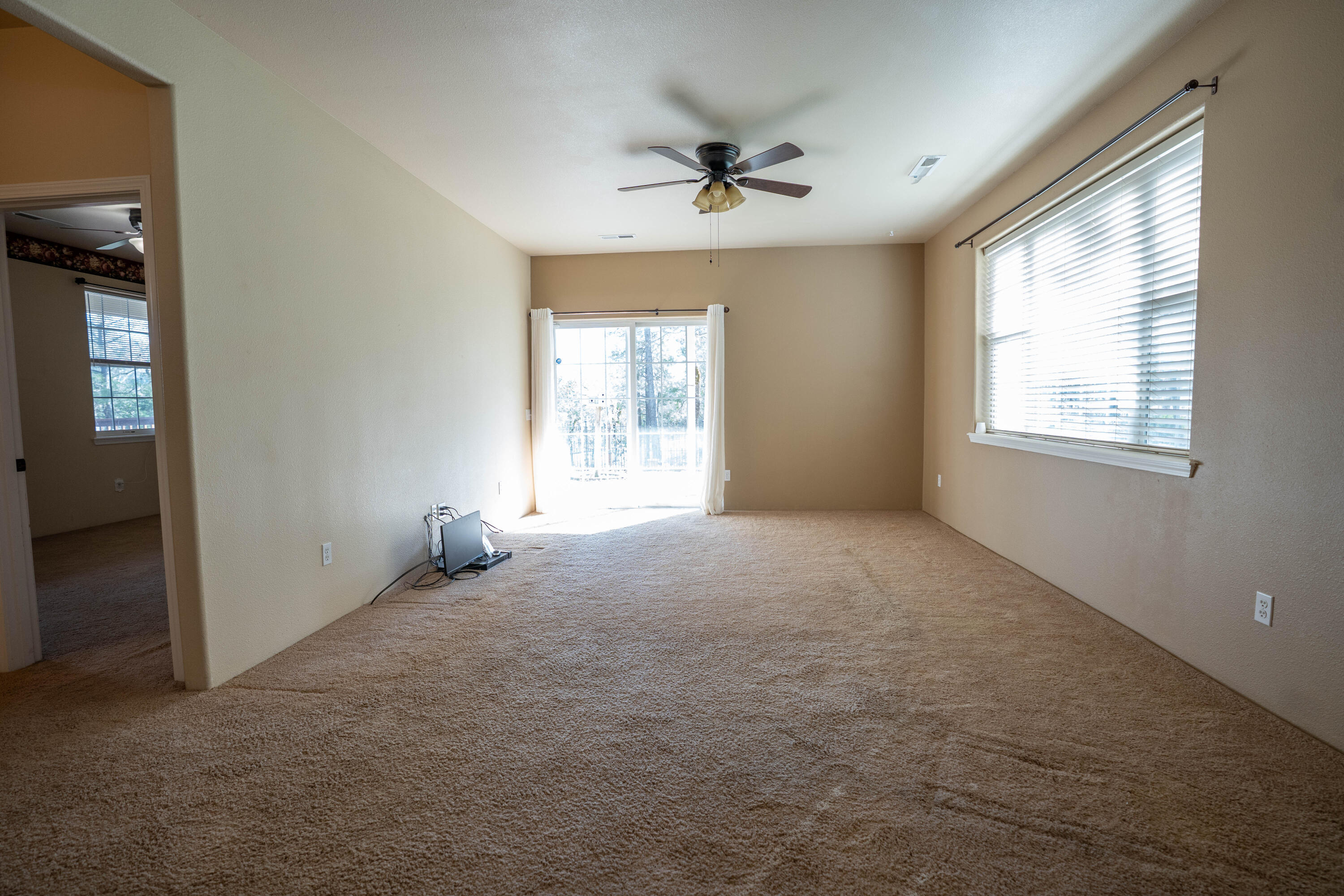 2080 Swingle Road Trail, OR 97541 - Photo 27 of 52 Secondary family room with patio access and additional bedrooms off the hallway.