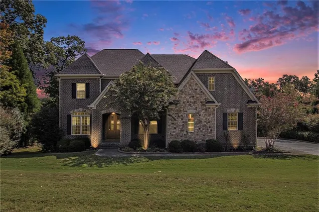 a front view of house with yard and green space
