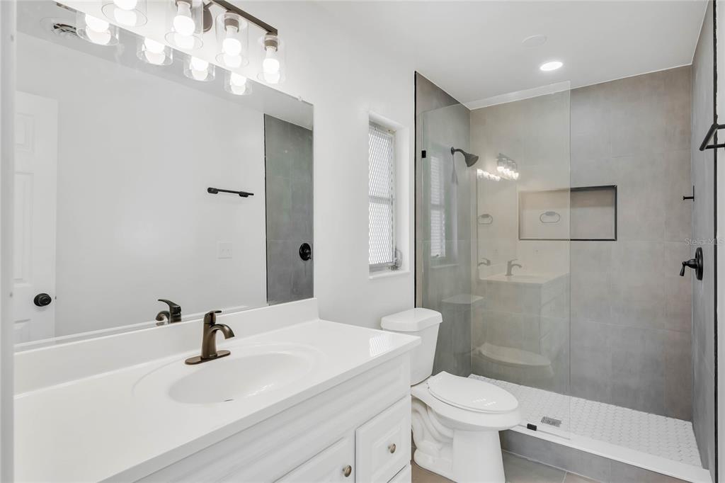 448 Ridge Drive Sanford, FL 32773 - Photo 14 of 20 a bathroom with a sink a toilet and shower