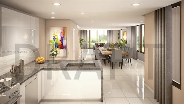 a dining hall with stainless steel appliances granite countertop a refrigerator and a sink