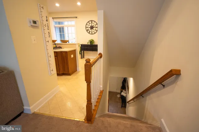 a view of a hallway with wooden floor and entryway
