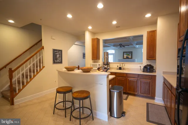 a large kitchen with a sink and living room