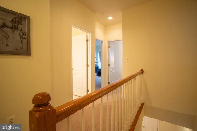 a view of a hallway with paintings on the wall
