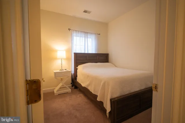 a bed room with a bed and a window