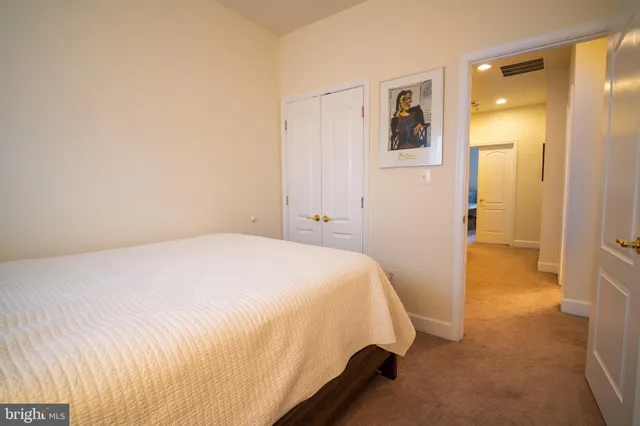 a bedroom with a bed and cabinets