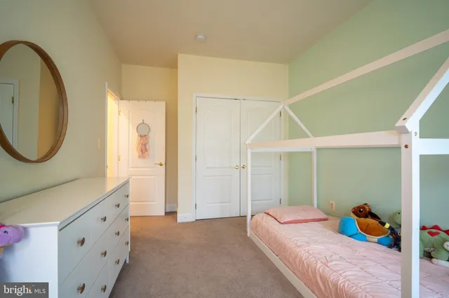 a bedroom with a bed and a mirror