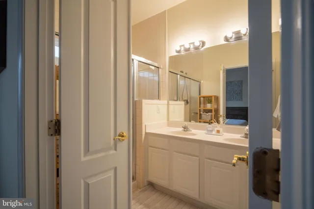 a bathroom with a double vanity sink and mirror