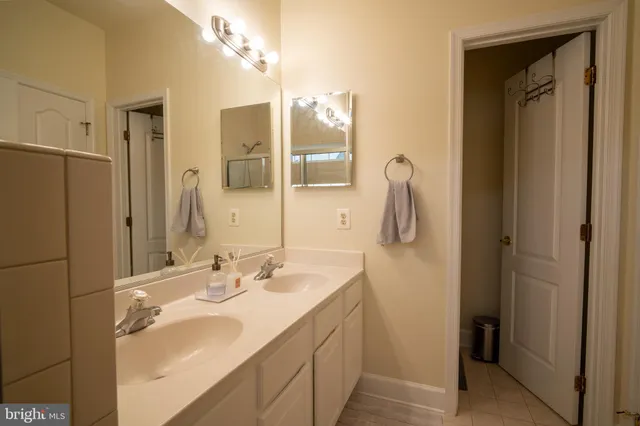 a bathroom with a shower sink and mirror