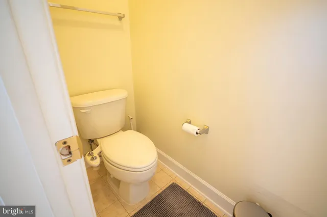 a white toilet sitting next to a shower