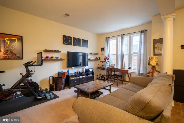 a living room with furniture and a flat screen tv