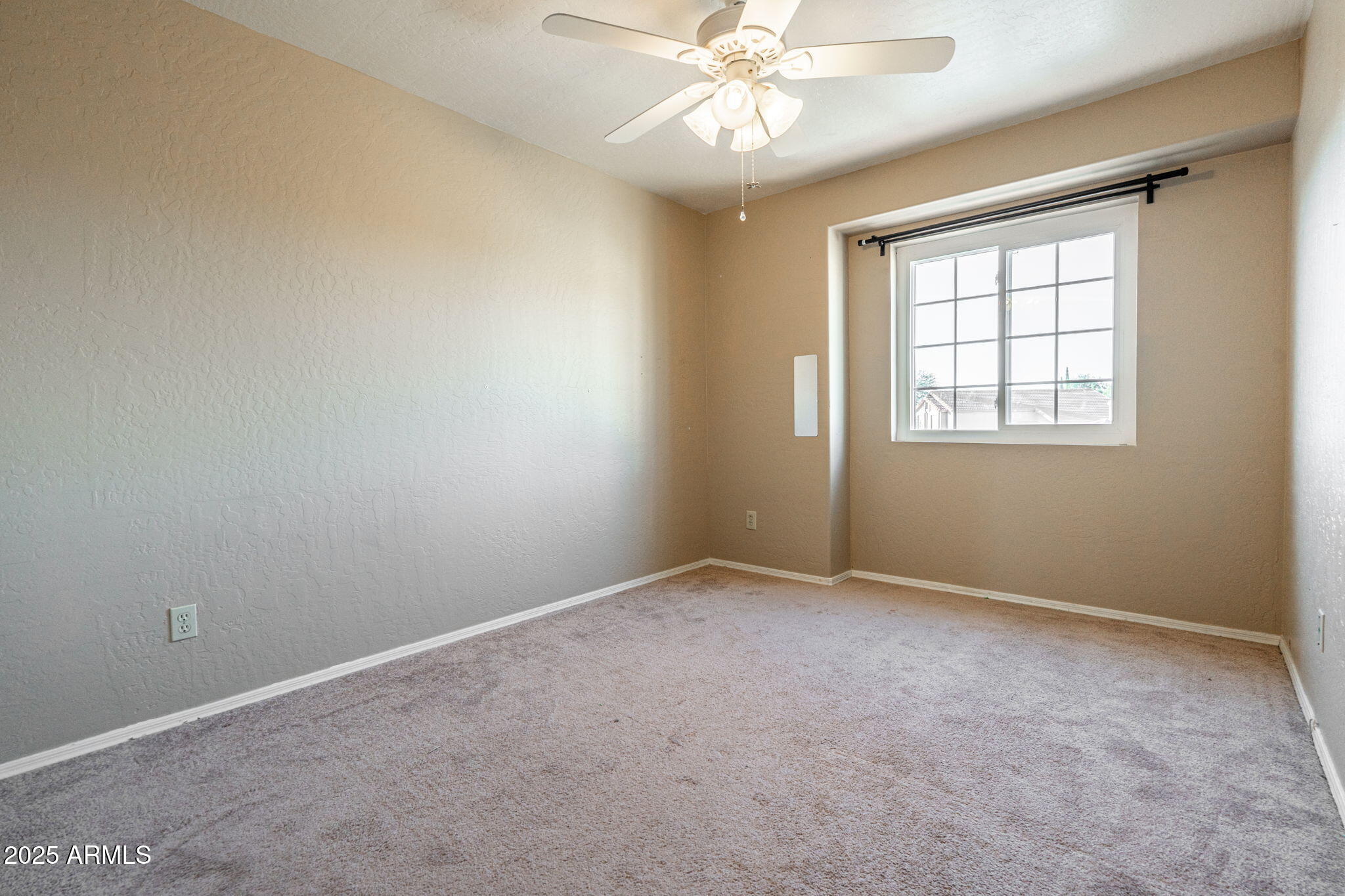 15601 South 37th Way Phoenix, AZ 85048 - Photo 22 of 28 an empty room with a window and a fan