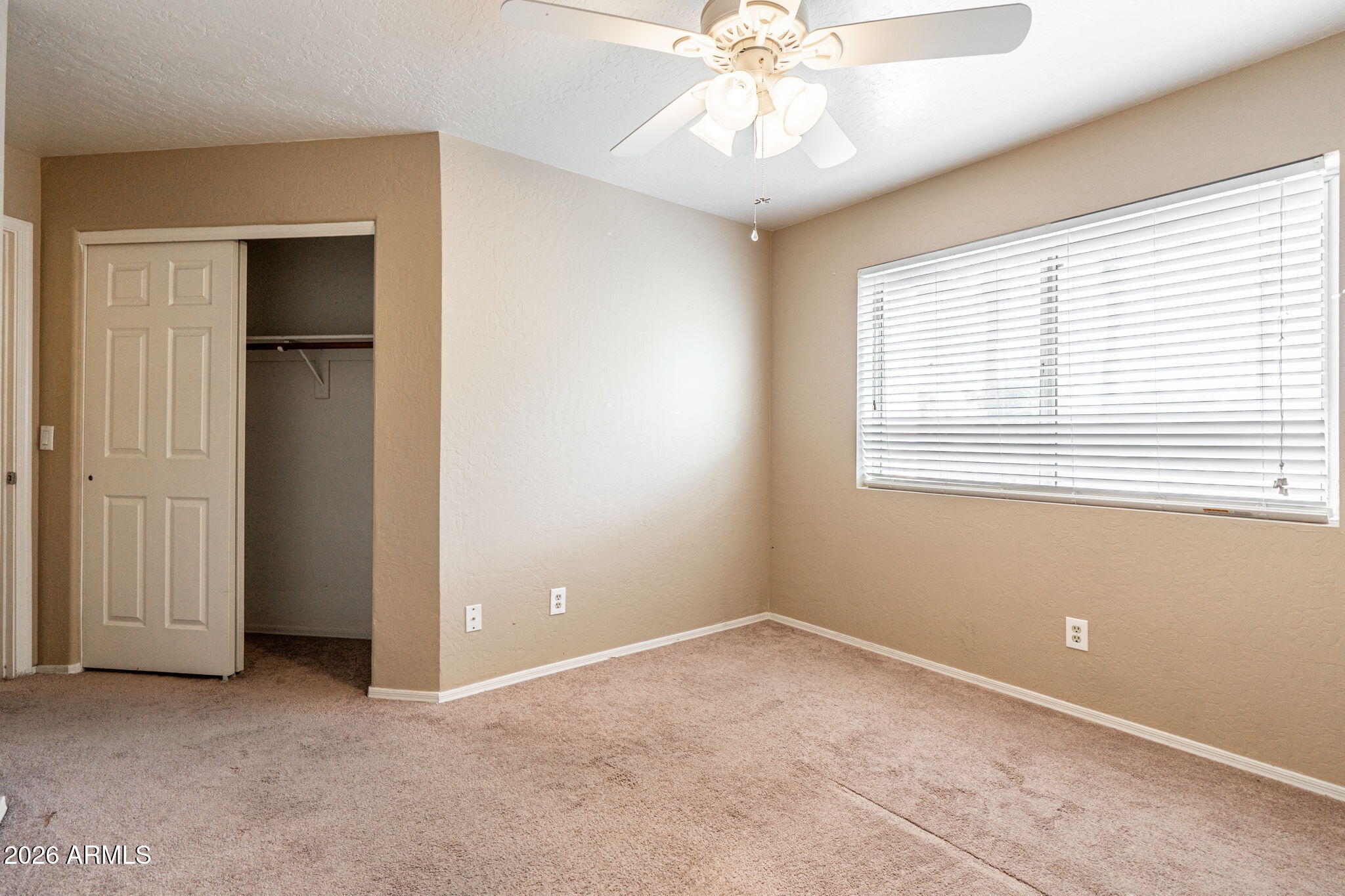 15601 South 37th Way Phoenix, AZ 85048 - Photo 26 of 38 an empty room with a window and a chandelier fan
