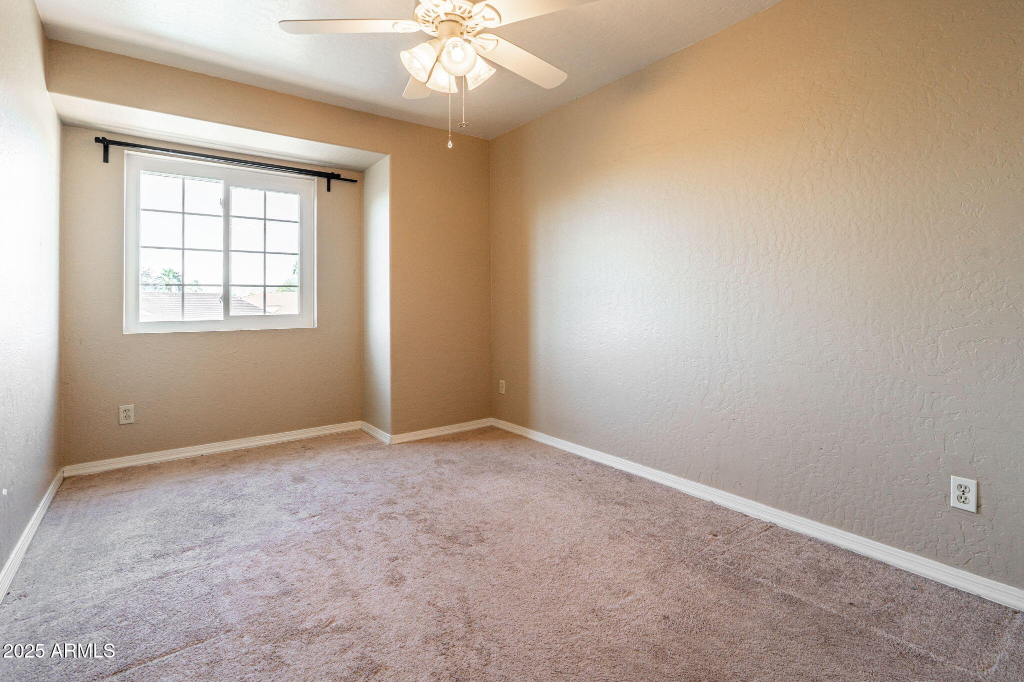 15601 South 37th Way Phoenix, AZ 85048 - Photo 28 of 38 an empty room with a chandelier fan and windows
