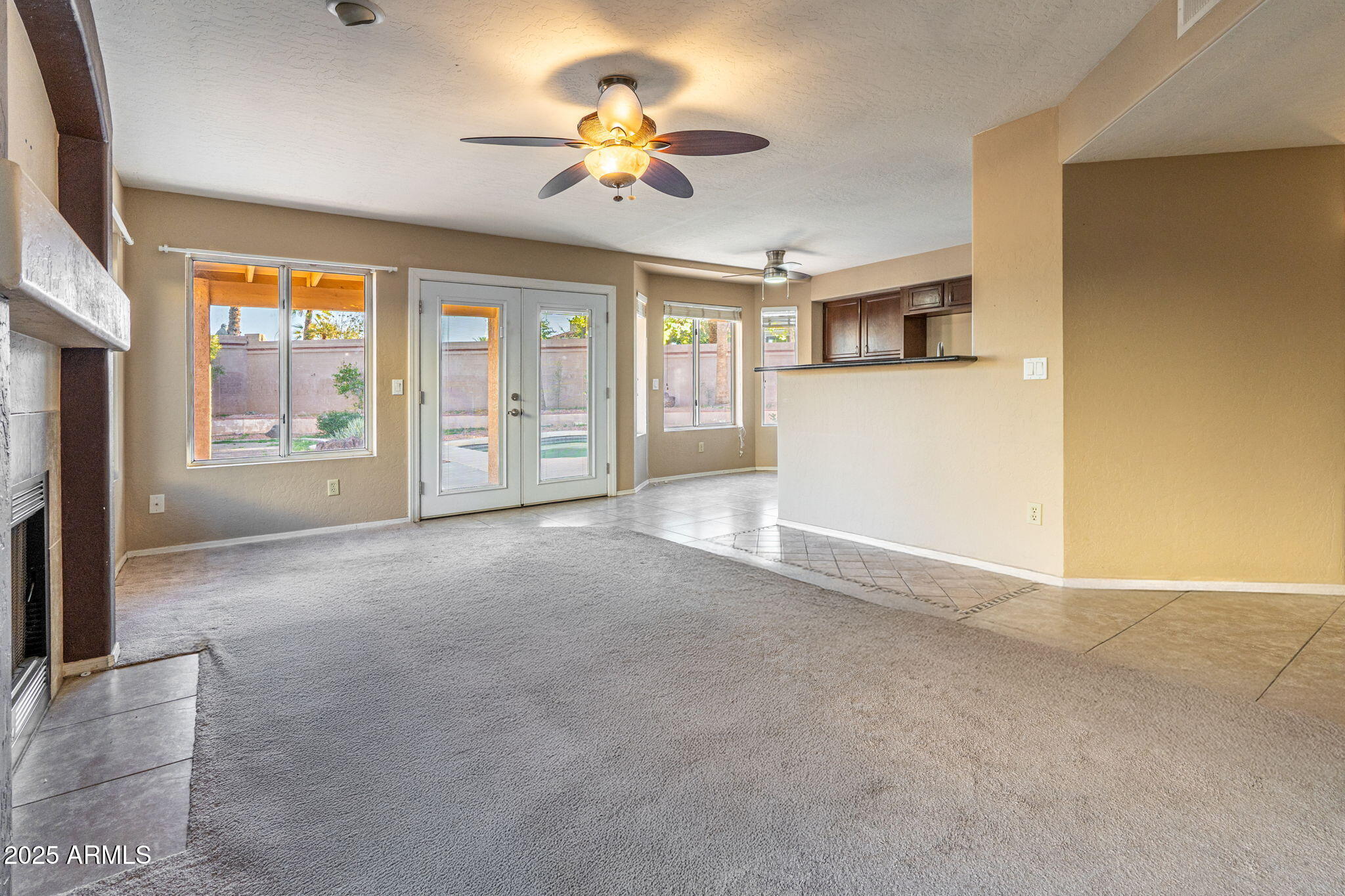 15601 South 37th Way Phoenix, AZ 85048 - Photo 6 of 28 a view of an empty room with a window and a kitchen