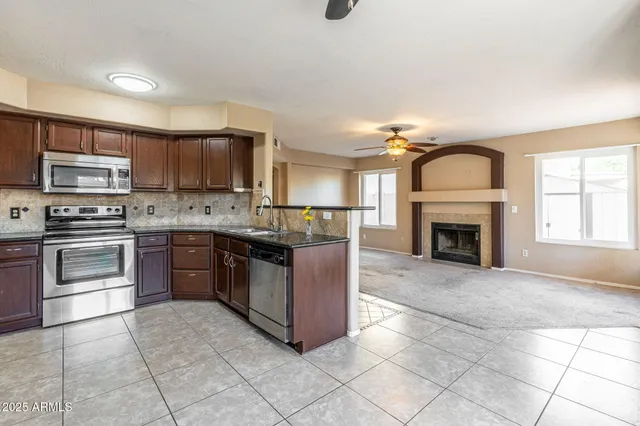 a large kitchen with cabinets and steel stainless steel appliances
