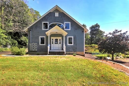 32 Portland Avenue, Unit 4 Redding, CT 06896 - Photo 1 of 1 a front view of a house with a yard