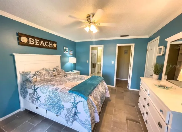 a bedroom with a large bed and a chandelier