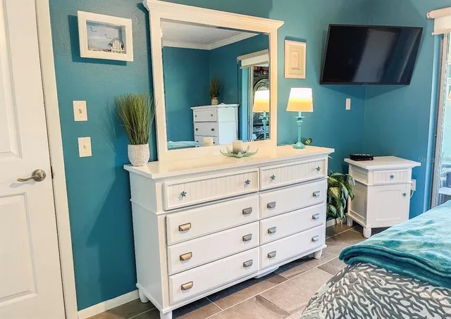 a room with a bed and a dresser