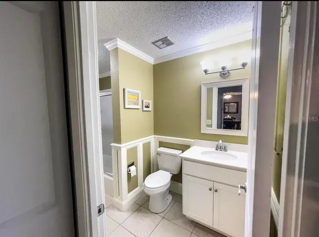 a bathroom with a toilet a sink and a mirror