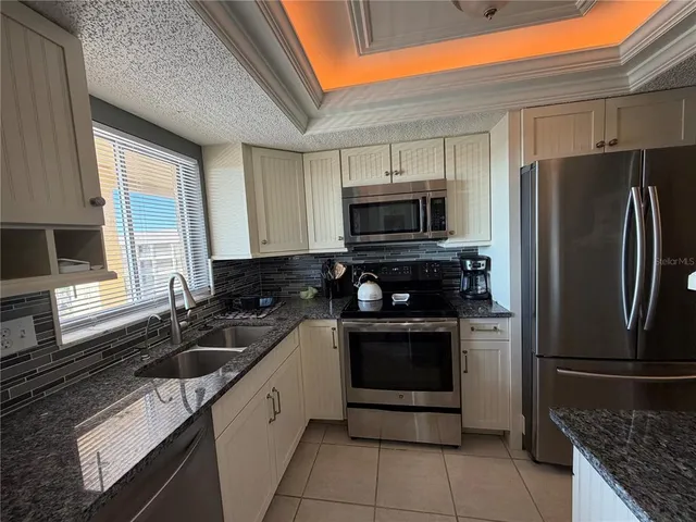 a kitchen with a sink stove and refrigerator