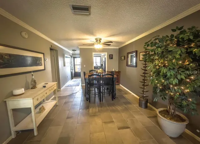 a dining room with furniture and a chandelier