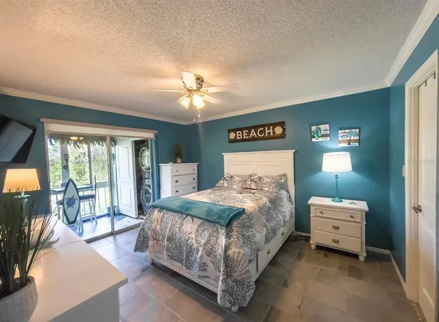 a bedroom with a bed a chandelier and a mirror