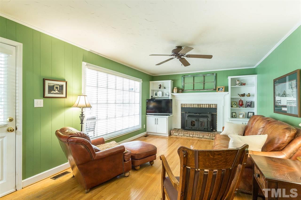 4300 Pike Road Raleigh, NC 27613 - Photo 14 of 28 a living room with furniture a fireplace and a flat screen tv