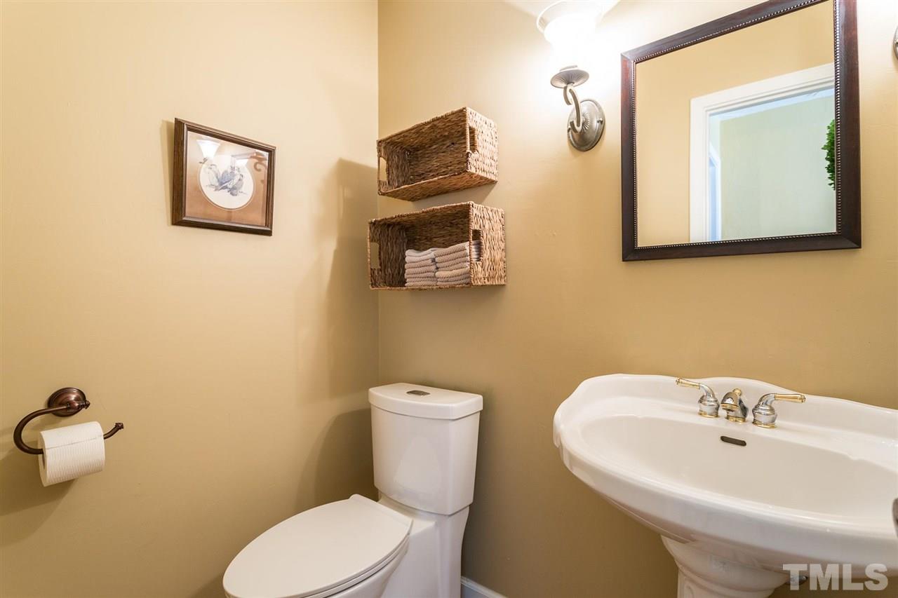 4300 Pike Road Raleigh, NC 27613 - Photo 22 of 28 a bathroom with a toilet a sink and mirror