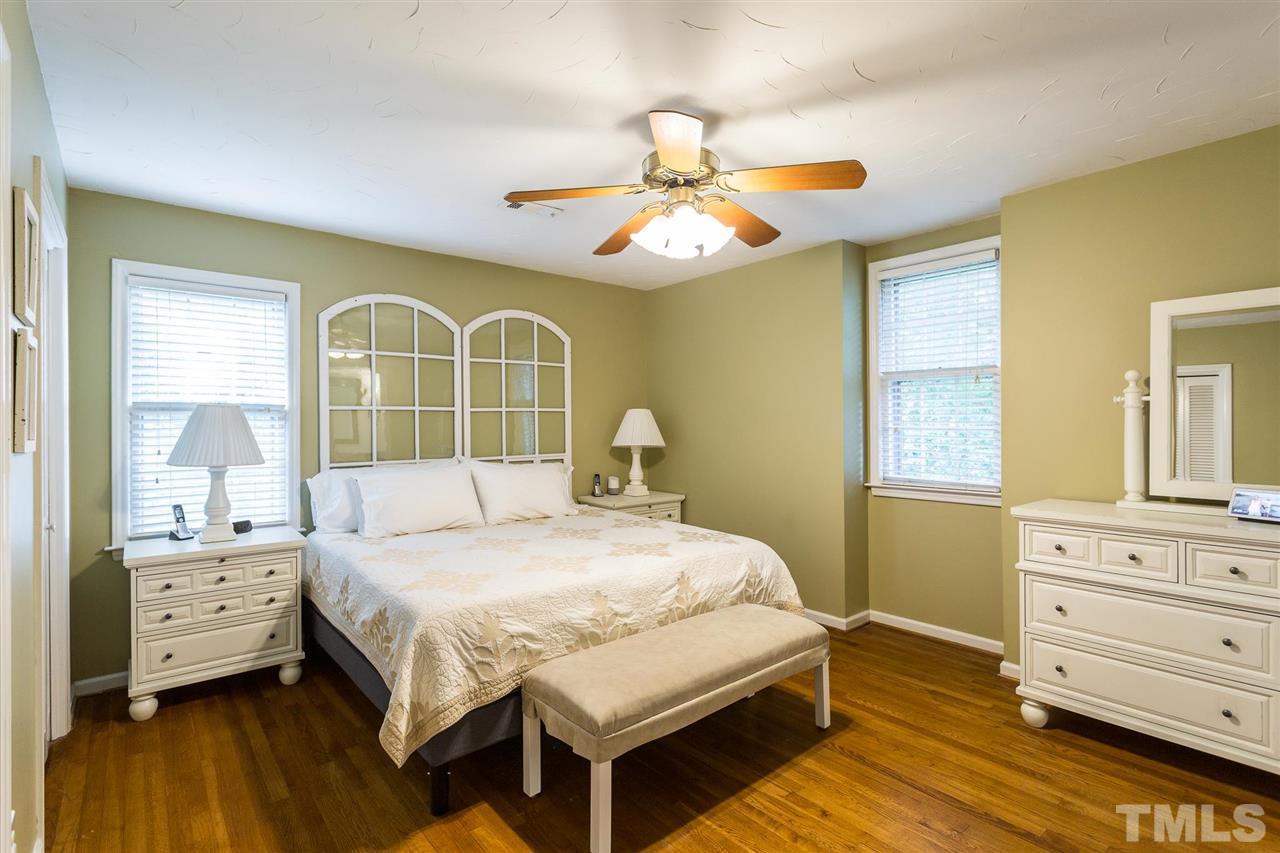 4300 Pike Road Raleigh, NC 27613 - Photo 23 of 28 a bedroom with a bed and wooden floor