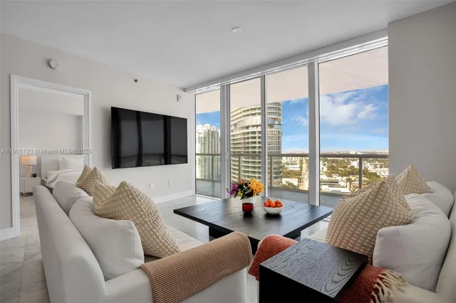 a living room with furniture and a large window