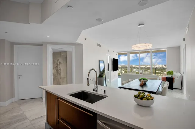 a kitchen with a sink a stove and cabinets