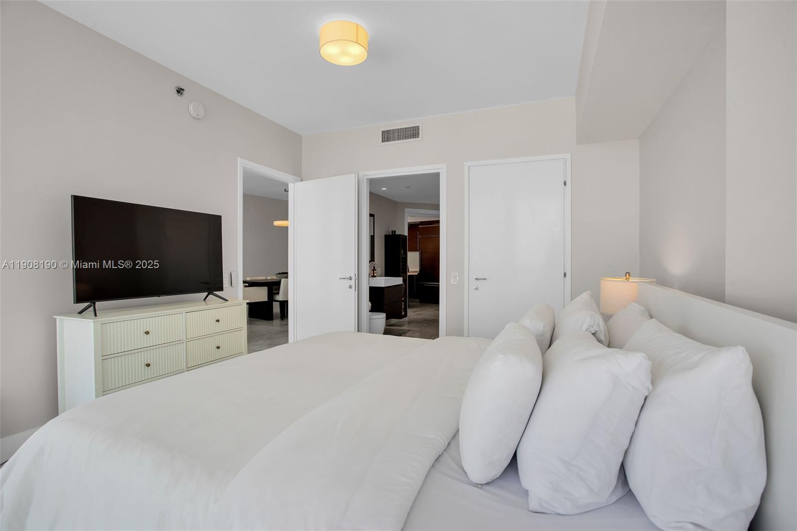 450 Alton Road, Unit 2110 Miami Beach, FL 33139 - Photo 13 of 33 a bedroom with a bed and a flat screen tv