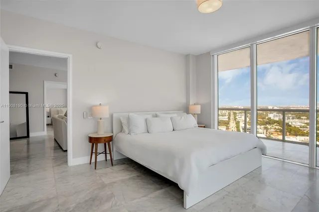 a large bed sitting in a bedroom and a table