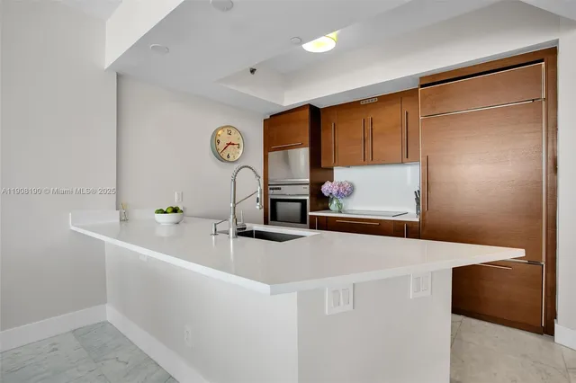 a kitchen with a sink and a refrigerator