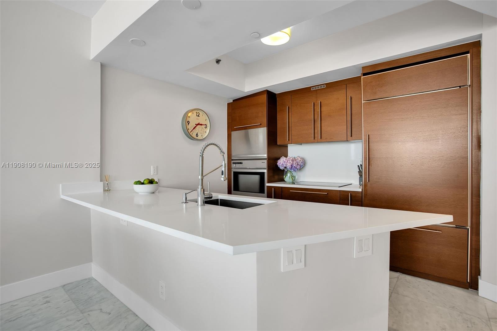 450 Alton Road, Unit 2110 Miami Beach, FL 33139 - Photo 7 of 33 a kitchen with a sink and a refrigerator