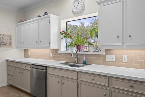 a kitchen with stainless steel appliances granite countertop a refrigerator sink and microwave