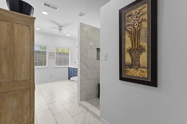 a spacious bathroom with a double vanity sink and a mirror