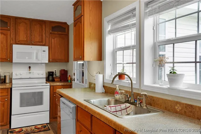 a kitchen with sink a window and appliances