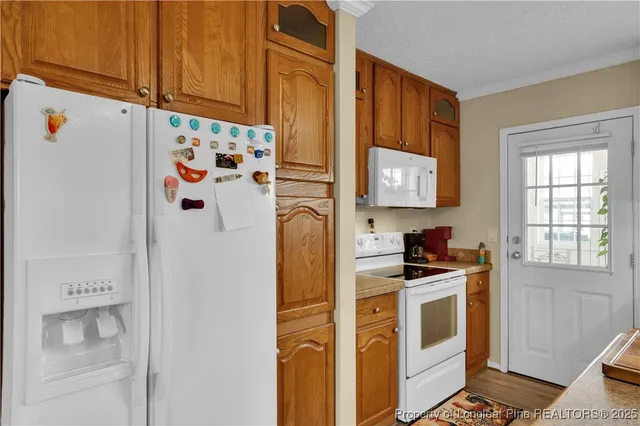 a kitchen with stainless steel appliances a refrigerator and a stove top oven