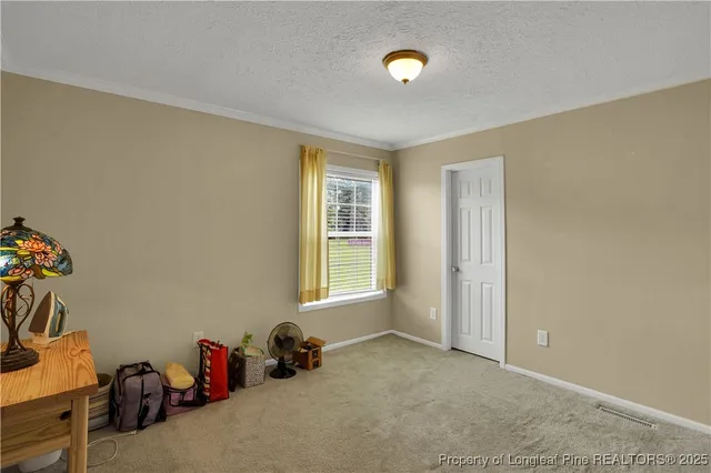 a view of a room with gym equipment and windows