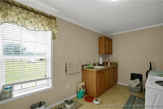 a kitchen with a stove a sink and a window